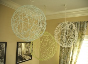 Yarn chandeliers hanging from ceiling.