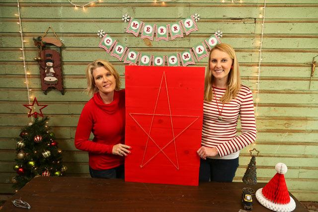 Kathy and Chelsea holding completed red Christmas card holder with string star