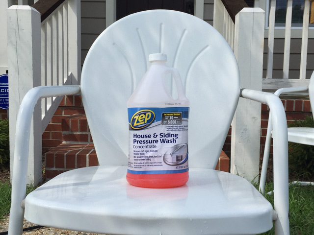 House and siding pressure washer cleaning solution soap container sitting on white chair