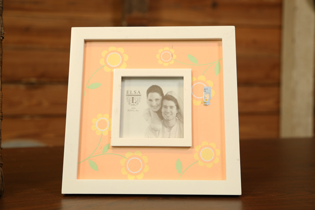 picture frame with orange flowers and white frame