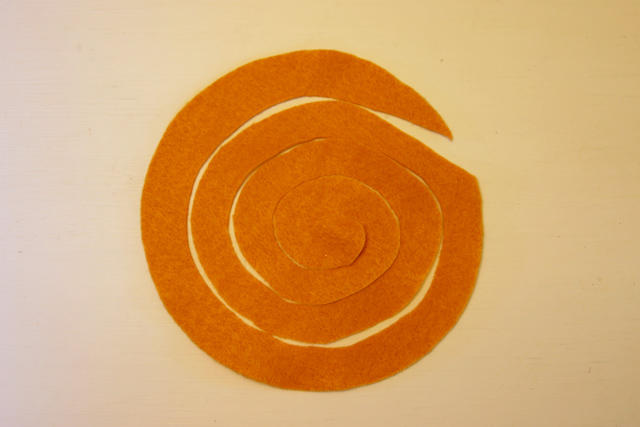 orange felt cut in spiral on white table