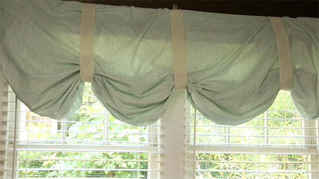 light blue no-sew valance curtain over white windows