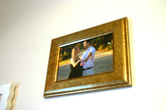 gold frame with husband and wife maternity photo it's a girl