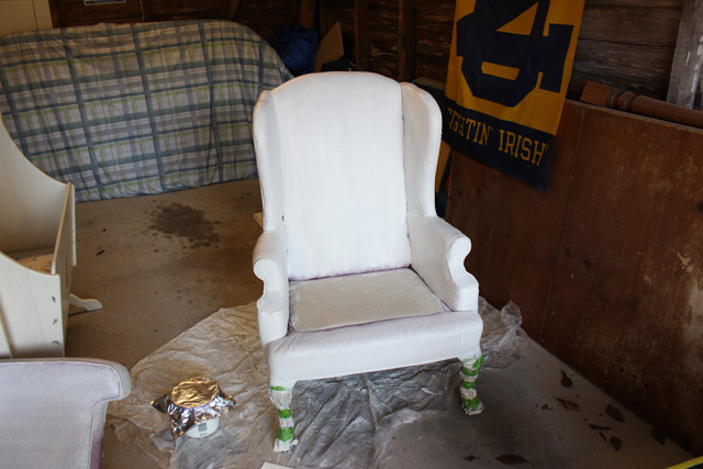 armchair being painted white in garage shop