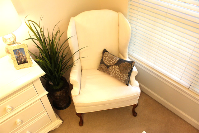 wingback armchair painted white in corner of bedroom