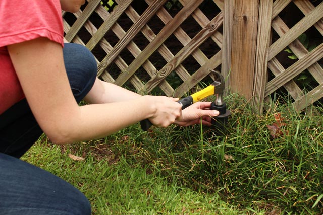 hammering light fixture plastic stake into ground