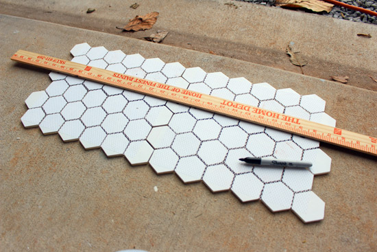 Using Yard Stick to Mark Back of Hexagon Tiles