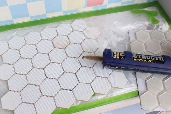 White Hexagon Tile with Tube of Construction Adhesive