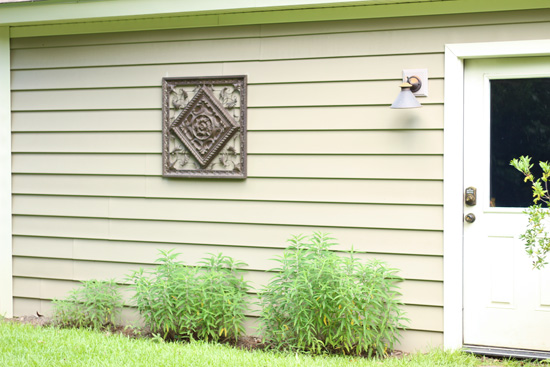 Metal Grate Hanging on Vinyl Sided Garage