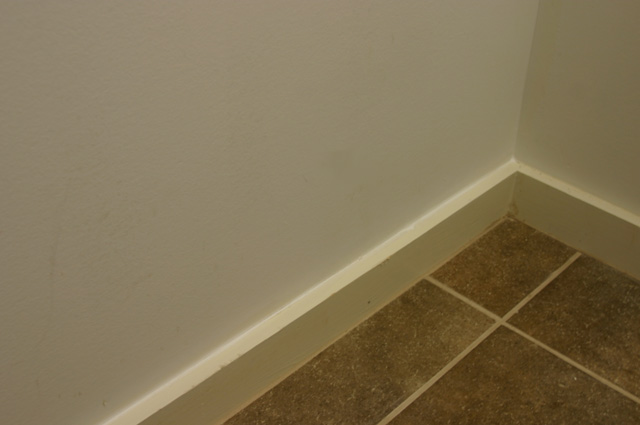 Caulking Baseboard in Laundry Room Before Painting