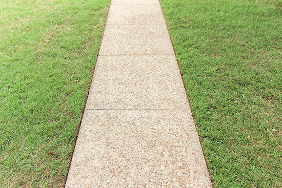 Freshly Edged Concrete Sidewalk with Green Grass