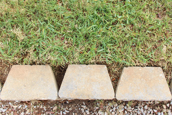 Green Grass Edged Behind Gray Pavestone Retaining Wall Blocks