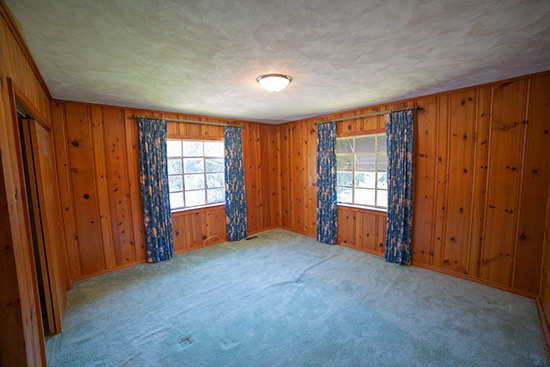 Pine Paneling Bedroom with Navy Curtains