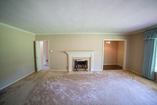 View of Living Room Front Door and Fireplace Wall