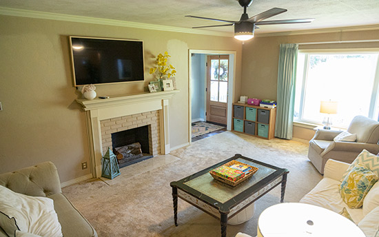 Family Room by Front Door with Fireplace Before