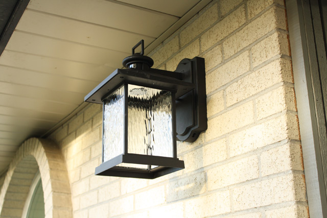 oil rubbed bronze carriage light on light-colored brick home