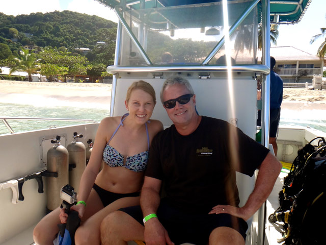 blonde daughter and dad sitting on boat in bathing suits Grenada