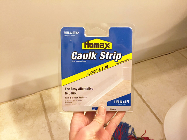 homax caulk strip in package in bathroom with tan tile and white bathtub