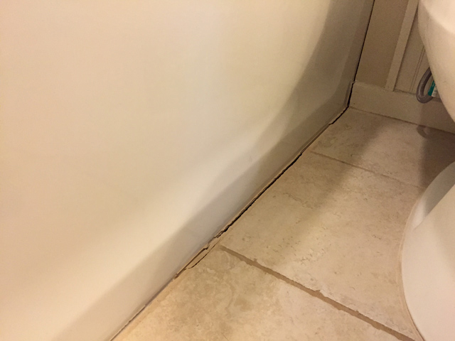 crack in grout between tile and bathtub 