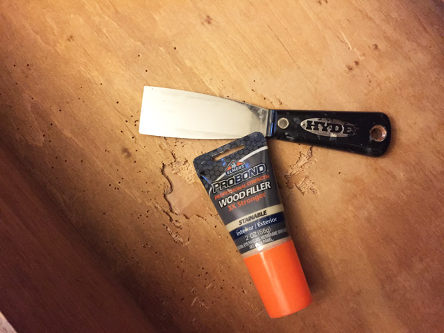 Elmer's wood filler and Hyde putty knife sitting in wood drawer