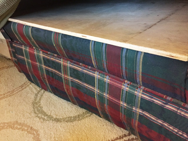 green blue and red plaid ouch with plywood under cushions for support