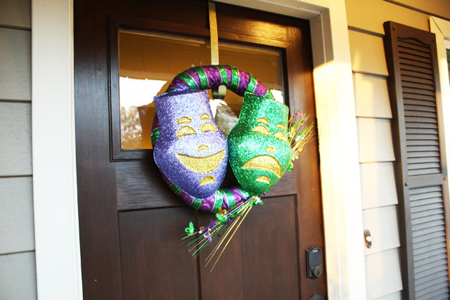 Mardi Gras wreath hanging on stained fiberglass front door