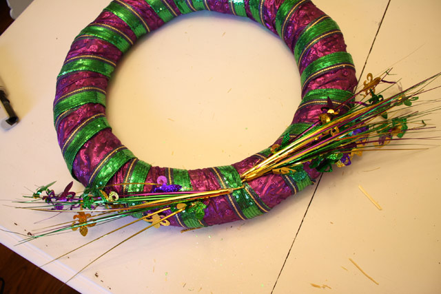 Mardi Gras purple, green, and gold wreath sitting on dining table