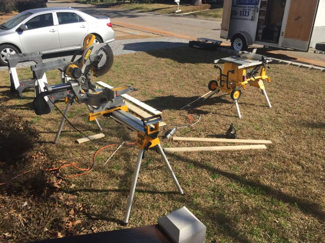 dewalt table saw miter saw in front yard with silver car in background