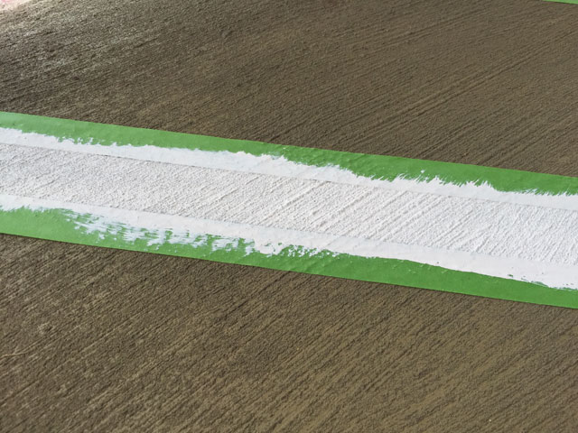 white paint stripe in green painter's tape