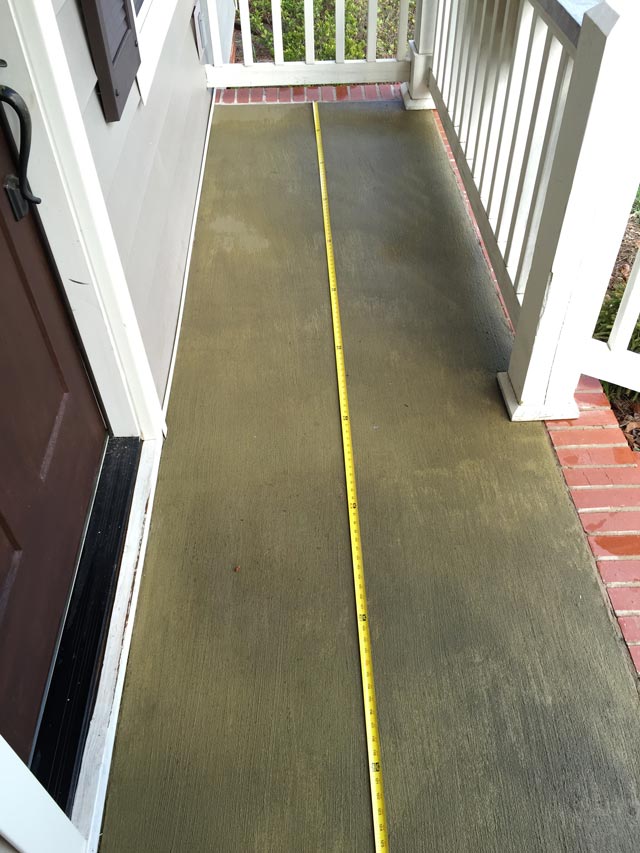 measuring concrete slab porch with yellow tape measure