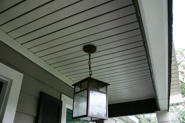 bronze pendant light hanging from white vinyl porch ceiling