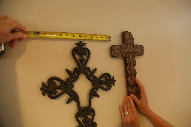 tape measure metal and wood crosses hanging on wall