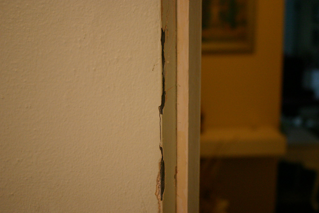green plaster walls peeling paint metal door strip