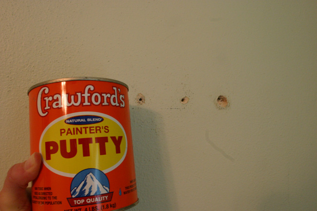 Crawford's painter's putty orange can green plaster wall with holes