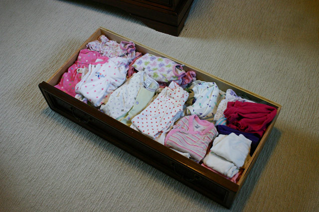 pink baby girl clothes in dresser drawer