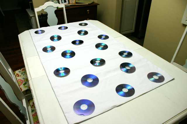 CDs laid on Roman shade for tracing