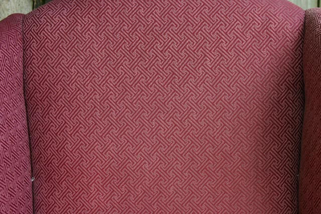 pattern on maroon wingback upholstered armchair