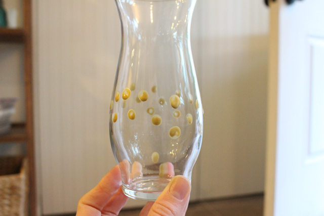 gold polka dots painted on small glass vase