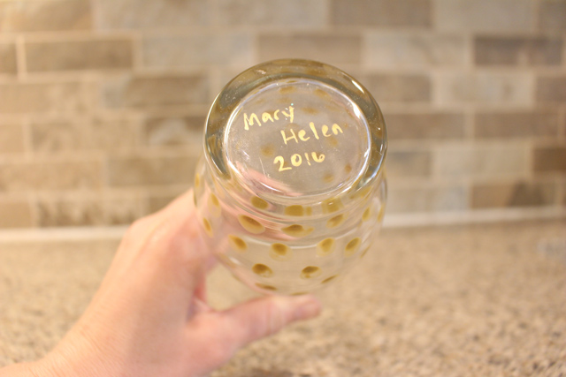 gold name written on bottom of glass vase