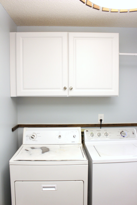 White Stock Cabinetry Hanging on Blue Wall