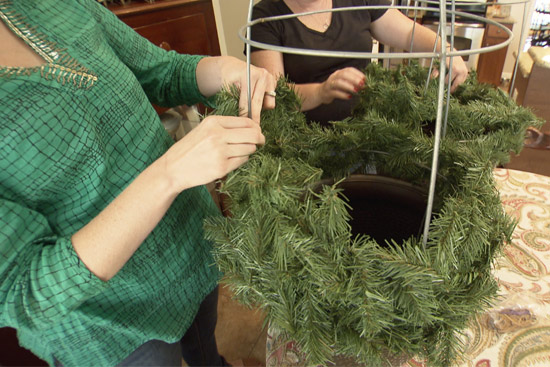 Wrapping Garland Around Tomato Cage in Planter