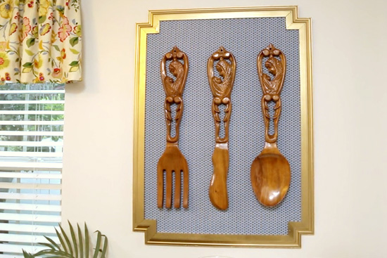 DIY frame to display wooden utensils on white dining room wall