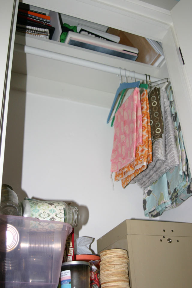 white closet fabric hanging storage shelf with books and frames