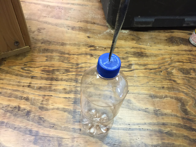 plastic soda bottle drill bit in lid