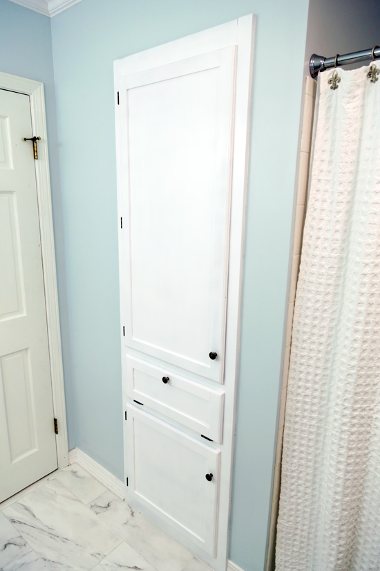 Built-In Linen Closet in Bathroom with Fresh White Paint