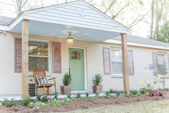 Cozy Painted Brick House with Curb Appeal Rocking Chair and Sage Green Front Door