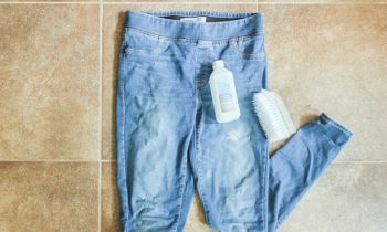 Denim Pants with Latex Paint on Them on Tile Floor with Rubbing Alcohol and Scrub Brush