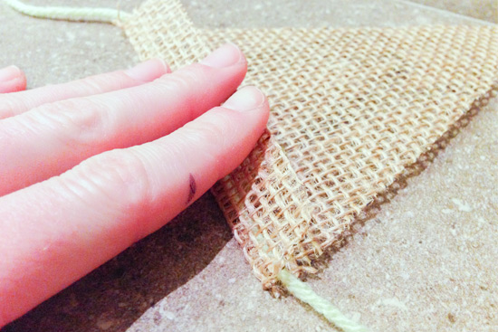 Folding Back of Burlap Over Green Yarn to Secure