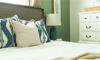 Wood Queen Headboard with White Duvet Navy Green Pillows