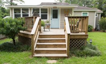 Rear View of Tan Vinyl House and Wood Deck